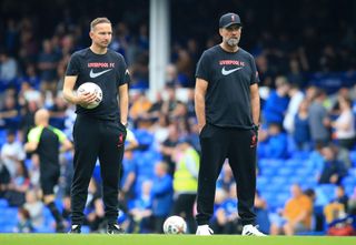 Liverpool manager Jurgen Klopp and assistant manager Pep Lijnders observe the warm-up ahead of their side's Premier League match against Everton, 2022