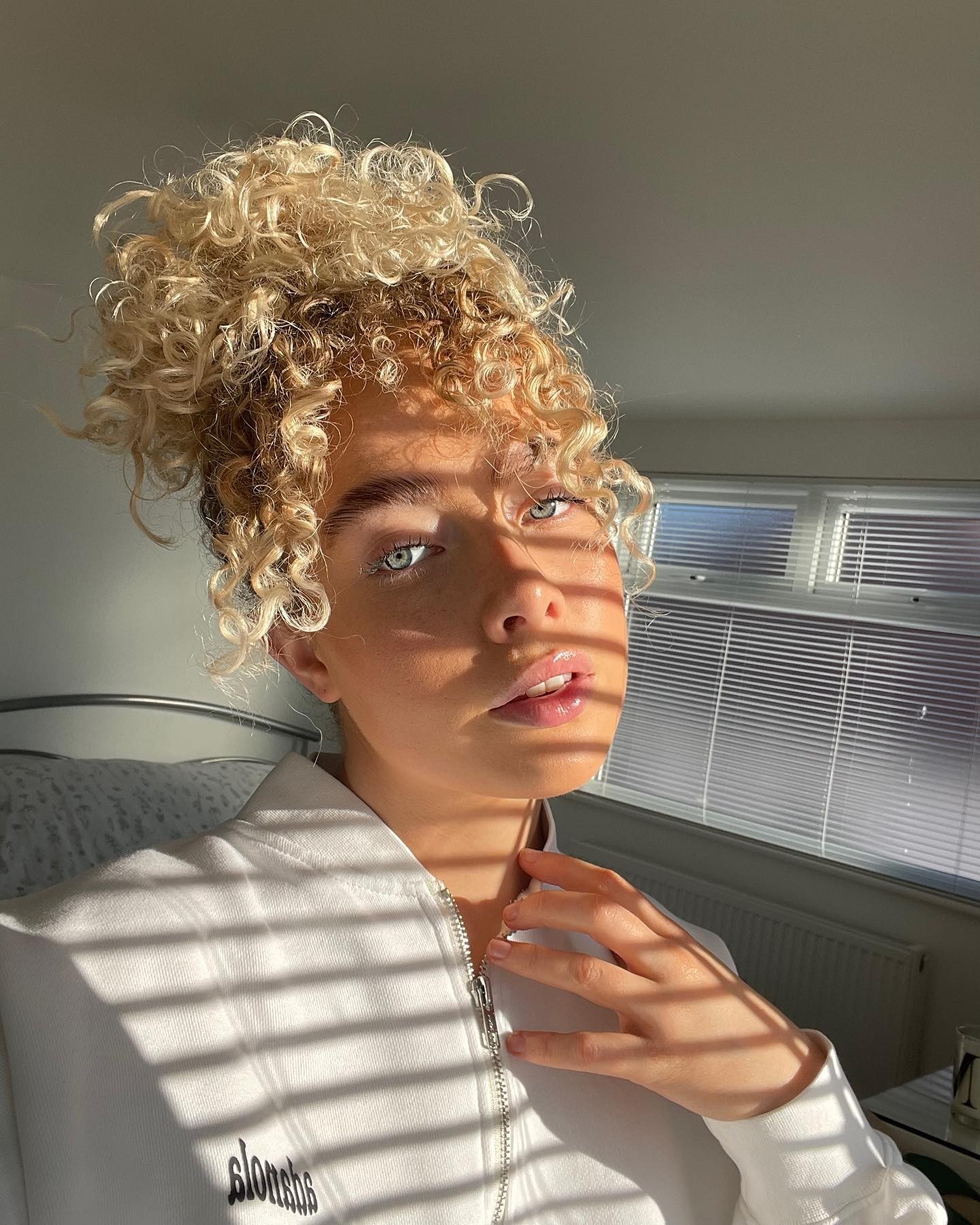 @martha.christiann with wispy curly bangs.