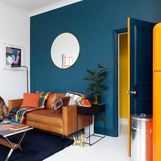 living area with blue wall and sofa with cushions