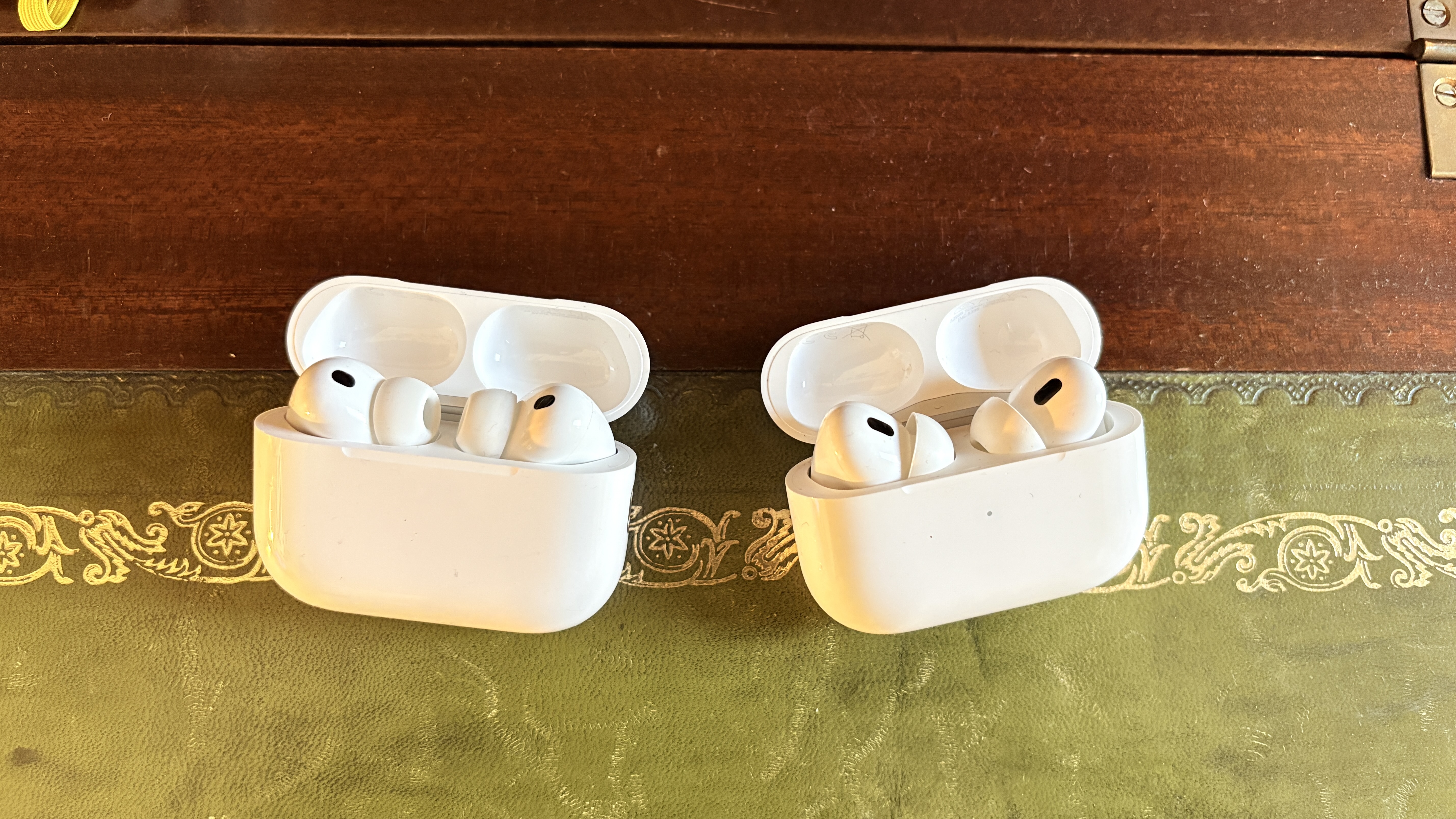 AirPods Pro 3 and AirPods Pro 2 placed next to each other on desk