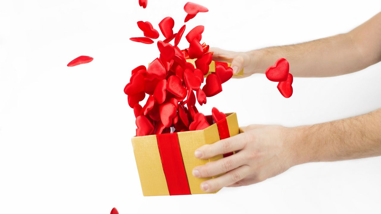 Little red hearts pop out of a gift box as it&#039;s opened.