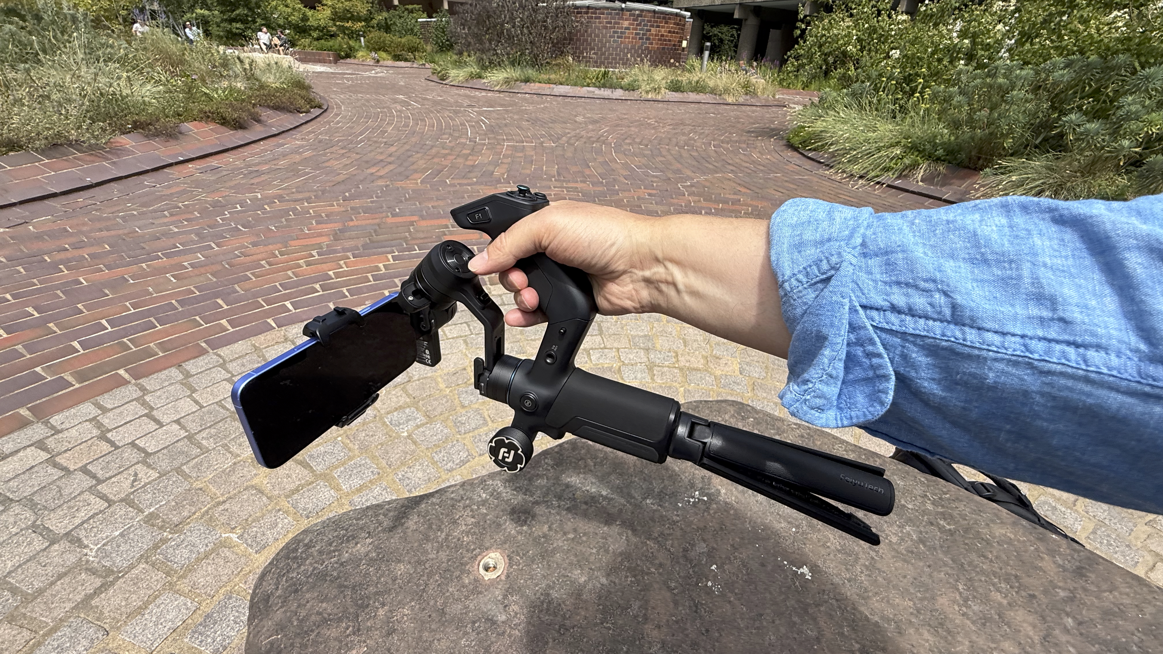 Shot of a hand holding the underslung handle, which enables you to maneuver the gimbal at a very low angle