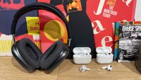Apple AirPods Max, AirPods Pro 2 and AirPods 3 in a row on desk with records