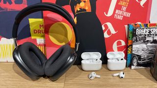 Apple AirPods Max, AirPods Pro 2 and AirPods 3 in a row on desk with records