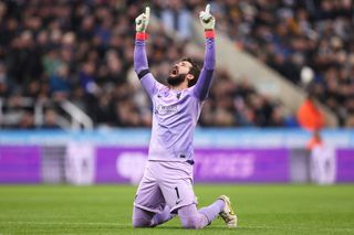 Alisson Becker of Liverpool celebrates after teammate Darwin Nunez scores the team's first goal during the Premier League match between Newcastle United and Liverpool FC at St. James Park on February 18, 2023 in Newcastle upon Tyne, England.