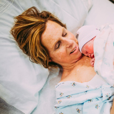 Cecile Raynek holding her granddaughter in hospital bed