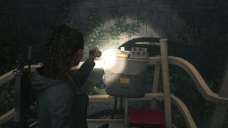 Alan Wake 2 screwdriver location - Saga is pointing her flashlight towards the yellow screwdriver on top of the control panel