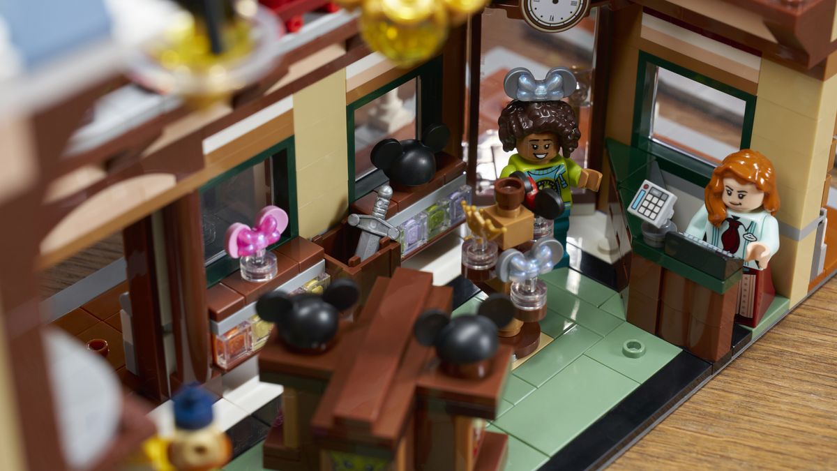Lego Main Street USA store, with customers and cast member behind the till