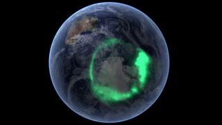 A green aurora rings part of the globe