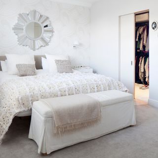 bedroom with white wall and white bed