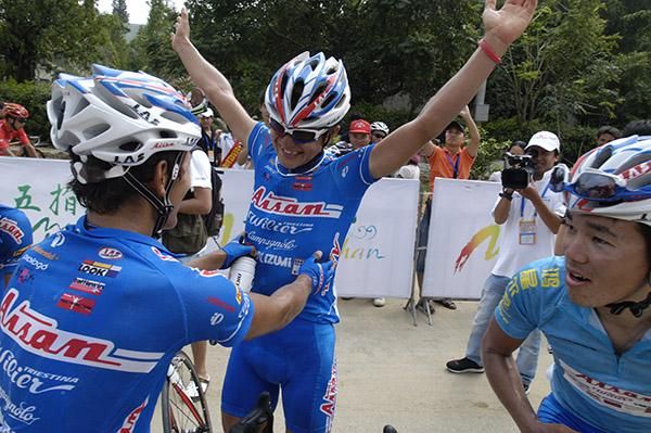 You beauty: Stage winner Nakajima Yasuharo celebrates his win with his Aisan Racing teammates.
