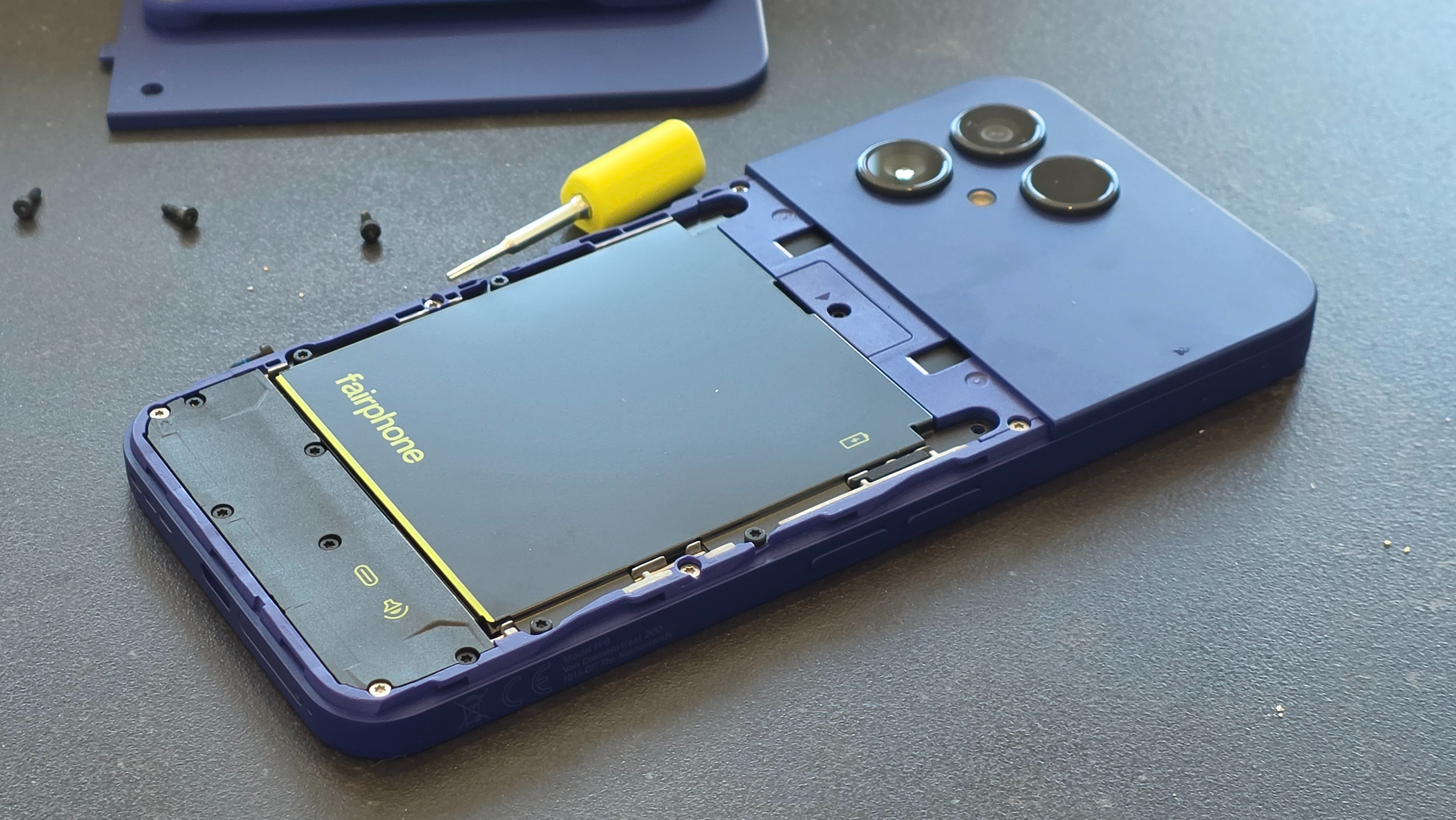The Fairphone Gen 6 Plus resting on a black table