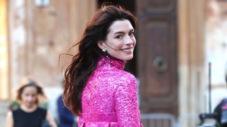 Anne Hathaway is seen with long burgundy brow hair whilst arriving at the Valentino Haute Couture Fall/Winter 22/23 fashion show on July 08, 2022 in Rome, Italy.