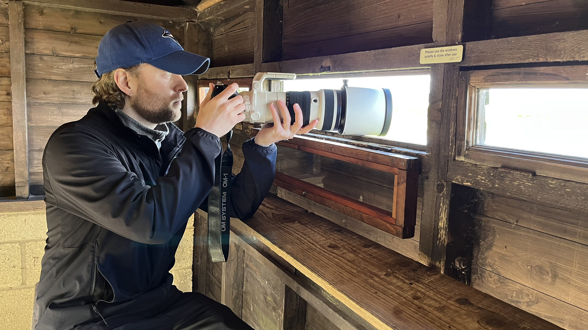 Mike Harris holding OM System M.Zuiko 150-400mm f/4.5 TC1.25x IS PRO at Slimbridge Wetland Centre