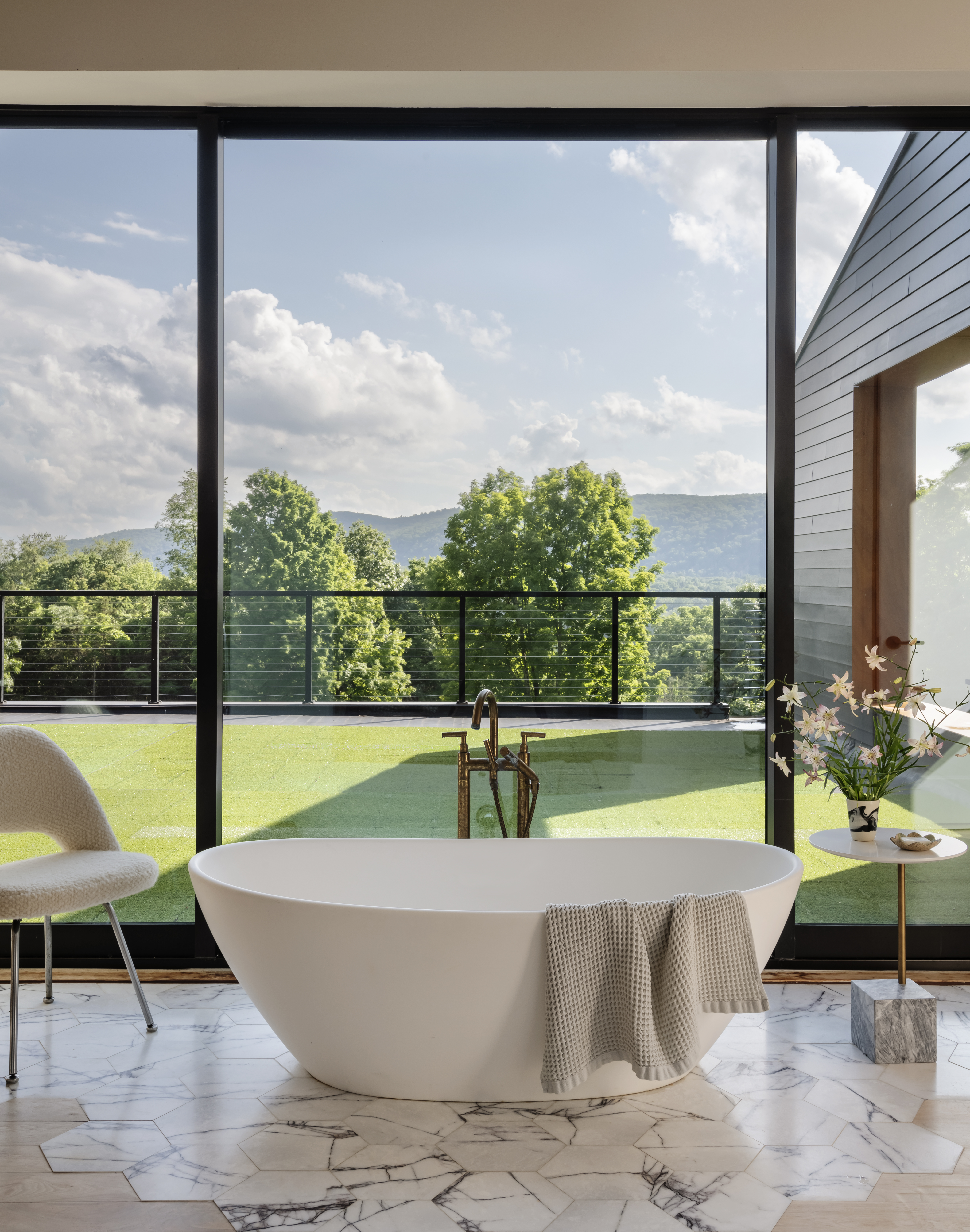A bathroom with fragmented stone tiles laid on a wooden flooring