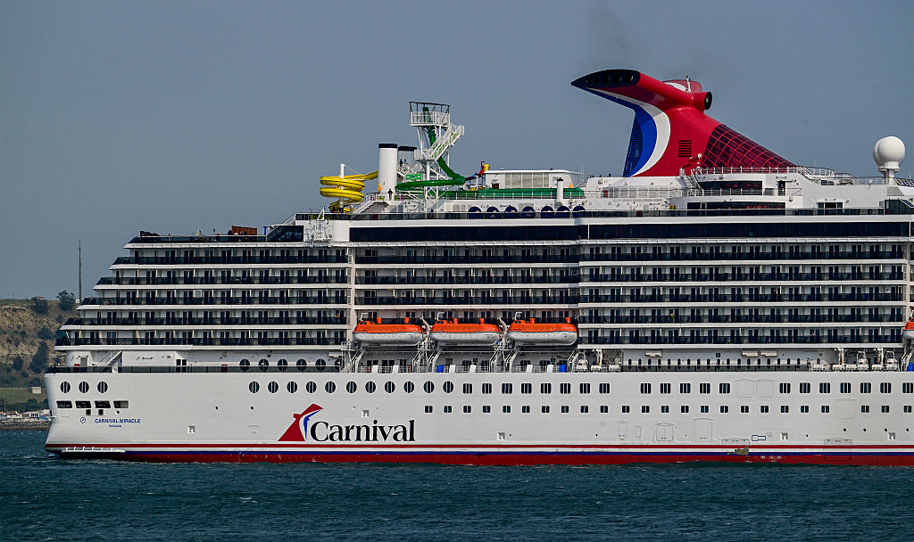 Carnival Miracle, a 88,500 GT Spirit-class cruise ship operated by Carnival Cruise Line, sails the Tagus River after departure from the cruise terminal on June 03, 2025, in Lisbon, Portugal.