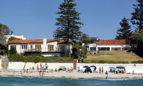 Beach goers enjoy Memorial day in front of Mitt Romney's La Jolla, Calif., house