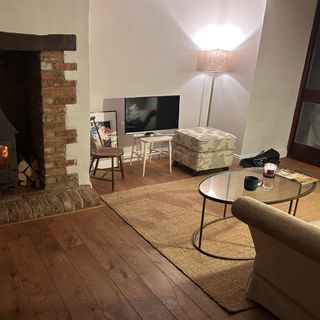 living room with chairs and pouffe