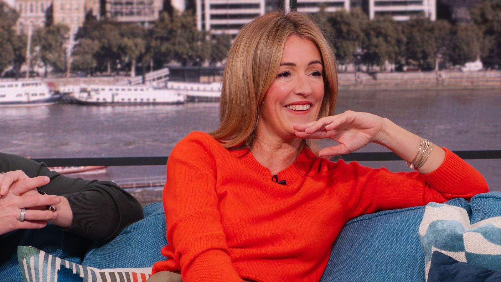 Cat Deeley in a red jumper on the This Morning sofa