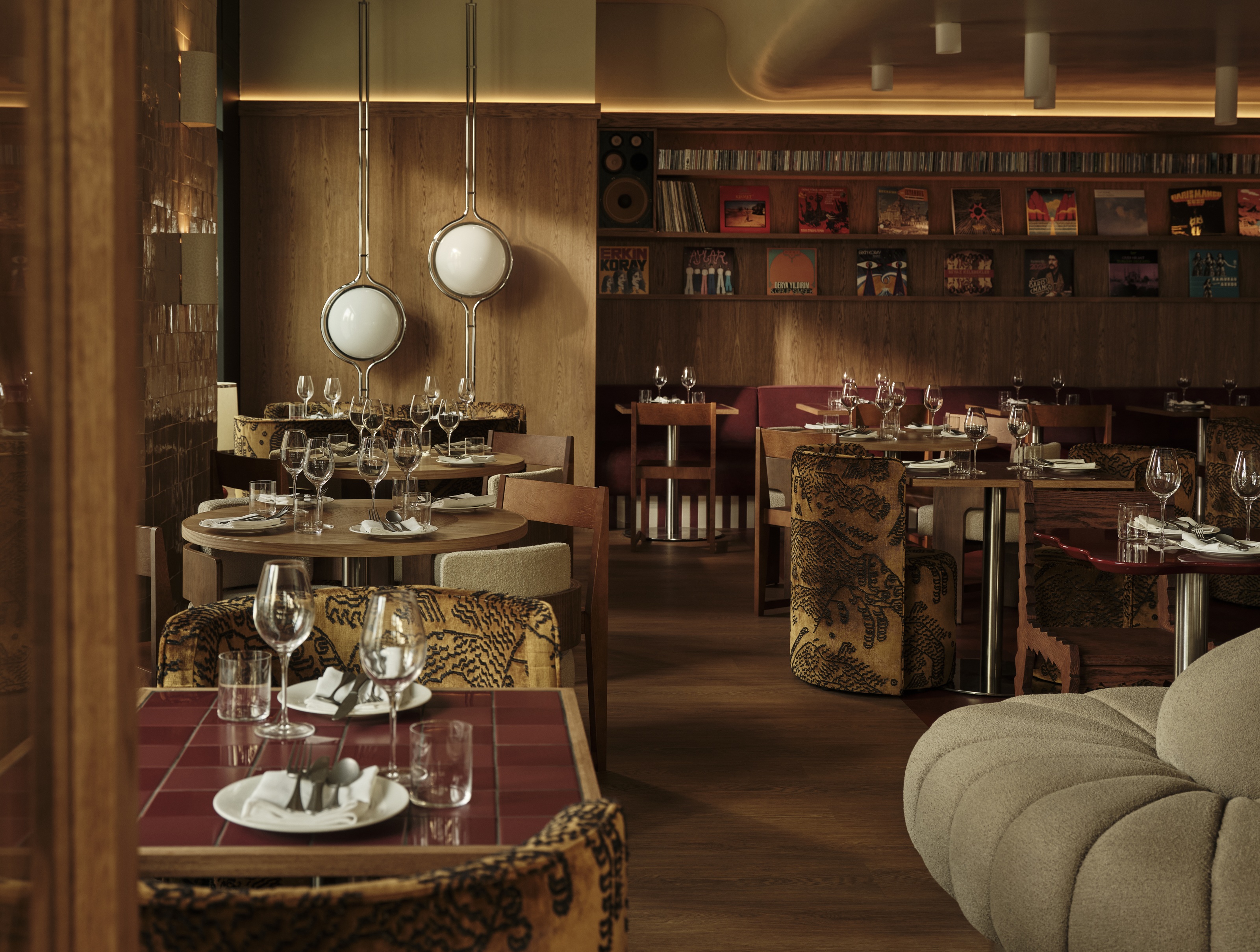 a restaurant with wood walls and vinyl records decorating