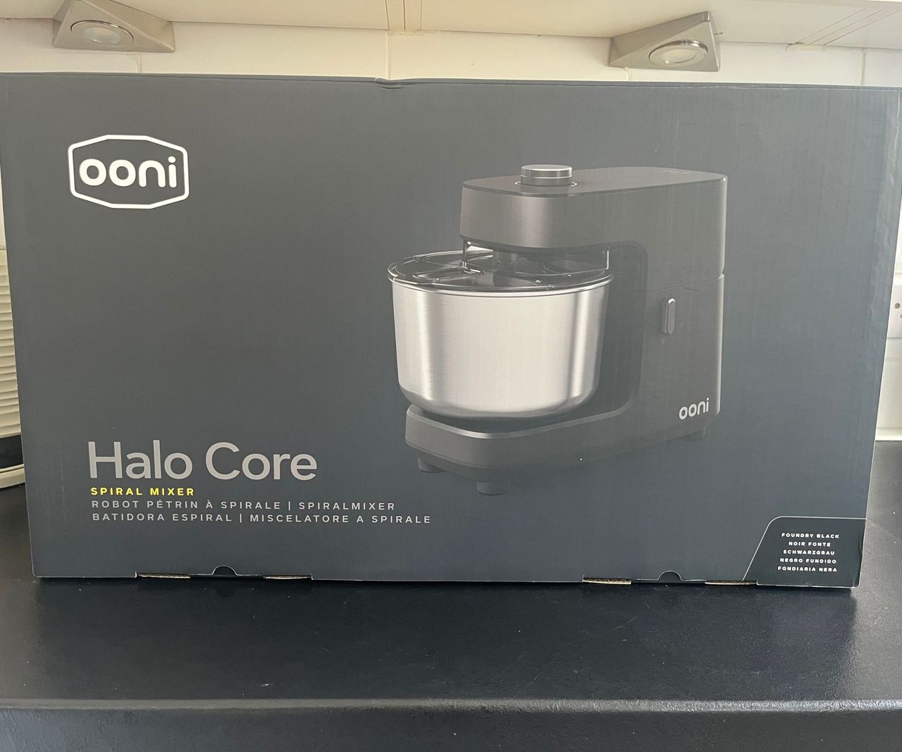 A black cardboard box with a Ooni Halo Core Spiral Mixer on the front