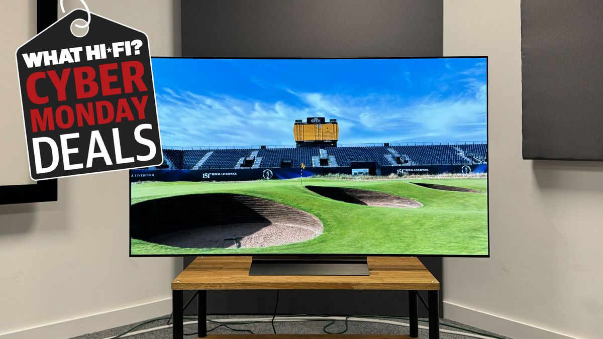 The 65-inch LG C4 photographed on a wooden stand with an image of a golf course on the screen