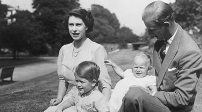 Princess Elizabeth and Prince Philip, Duke of Edinburgh with their two children, Prince Charles and Princess Anne in the grounds of Clarence House, London.