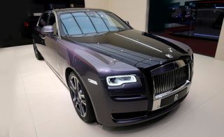 A purple Rolls-Royce Ghost photographed from the front in a car show room