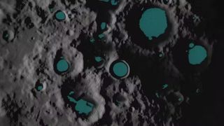 a rocky grey surface with craters filled-in with dark blue/green