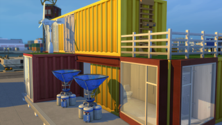A shipping container home in The Sims 4, with wind turbines and dew collectors