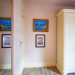 Typography and vintage seascape painting hanging on bedroom wall