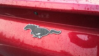 ford mustang logo on red car