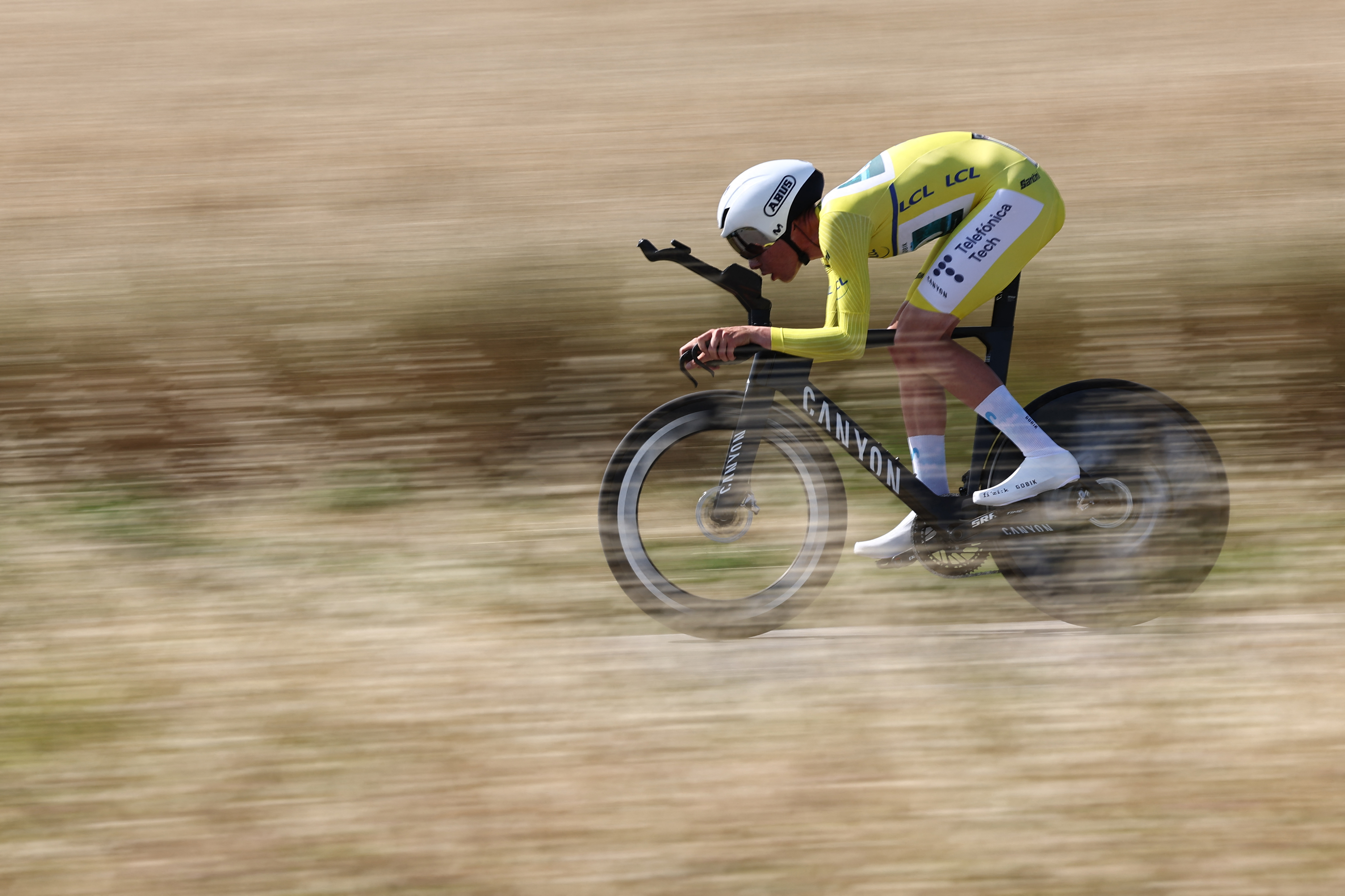 Movistar Team's Spanish rider Ivan Romeo Abad wearing the overall leader's yellow jersey cycles during the 4th stage of the 77th edition of the Criterium du Dauphine cycling race, a 17,4 km individual time trial between Charmes-sur-Rhône and Saint-Péray, on June 11, 2025. (Photo by Anne-Christine POUJOULAT / AFP) (Photo by ANNE-CHRISTINE POUJOULAT/AFP via Getty Images)