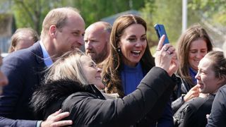 Prince William, Duke of Cambridge and Catherine, Duchess of Cambridge meet members of the public during a visit to the Wheatley Group