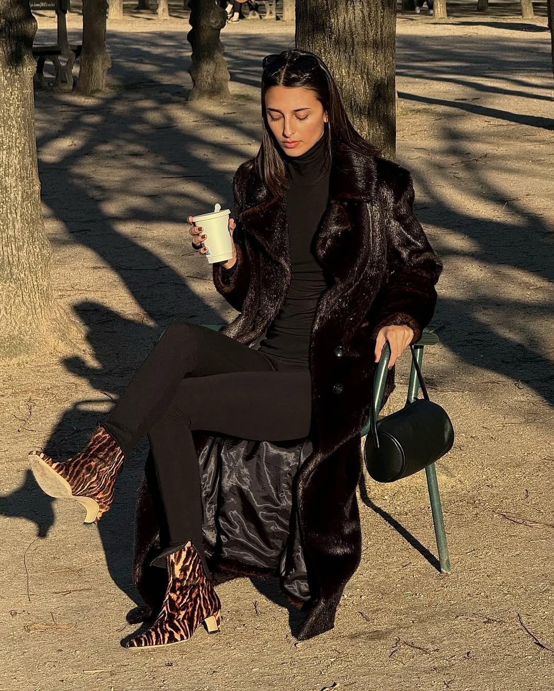 French woman wearing all brown outfit and zebra boots.