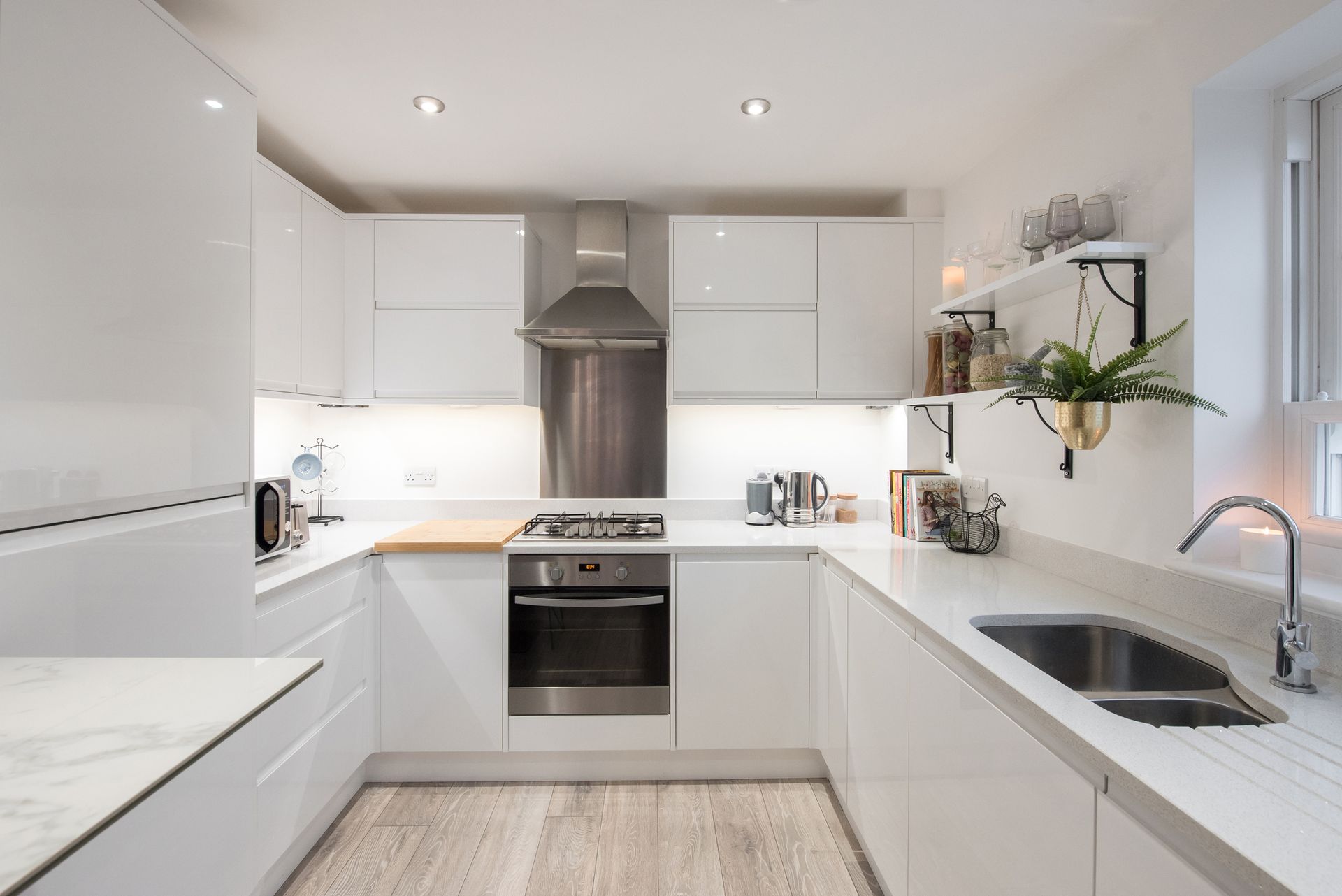 a clean white modern kitchen that is well organized