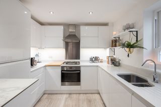 a clean white modern kitchen that is well organized