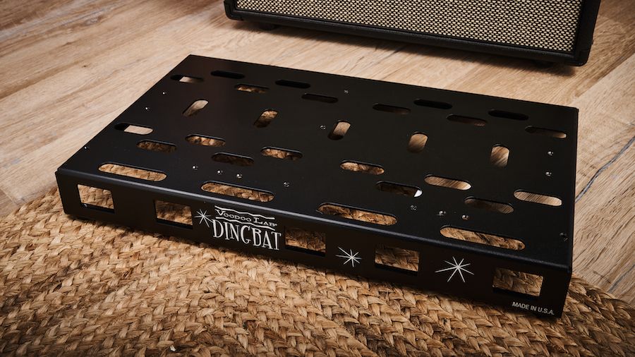 A Voodoo Labs Dingbat Medium pedalboard on a rug