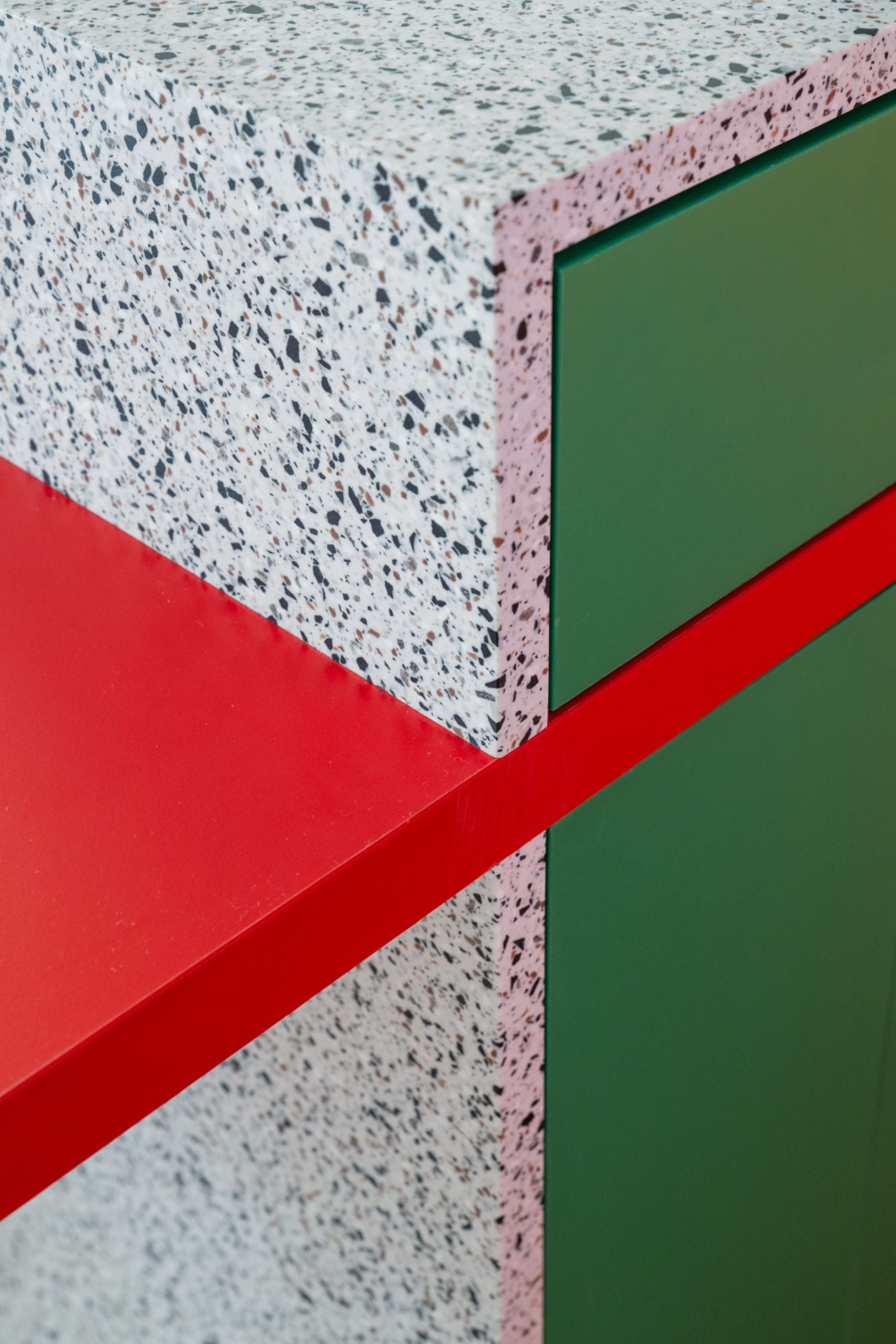 Kitchen island paired with red and green cabinetry
