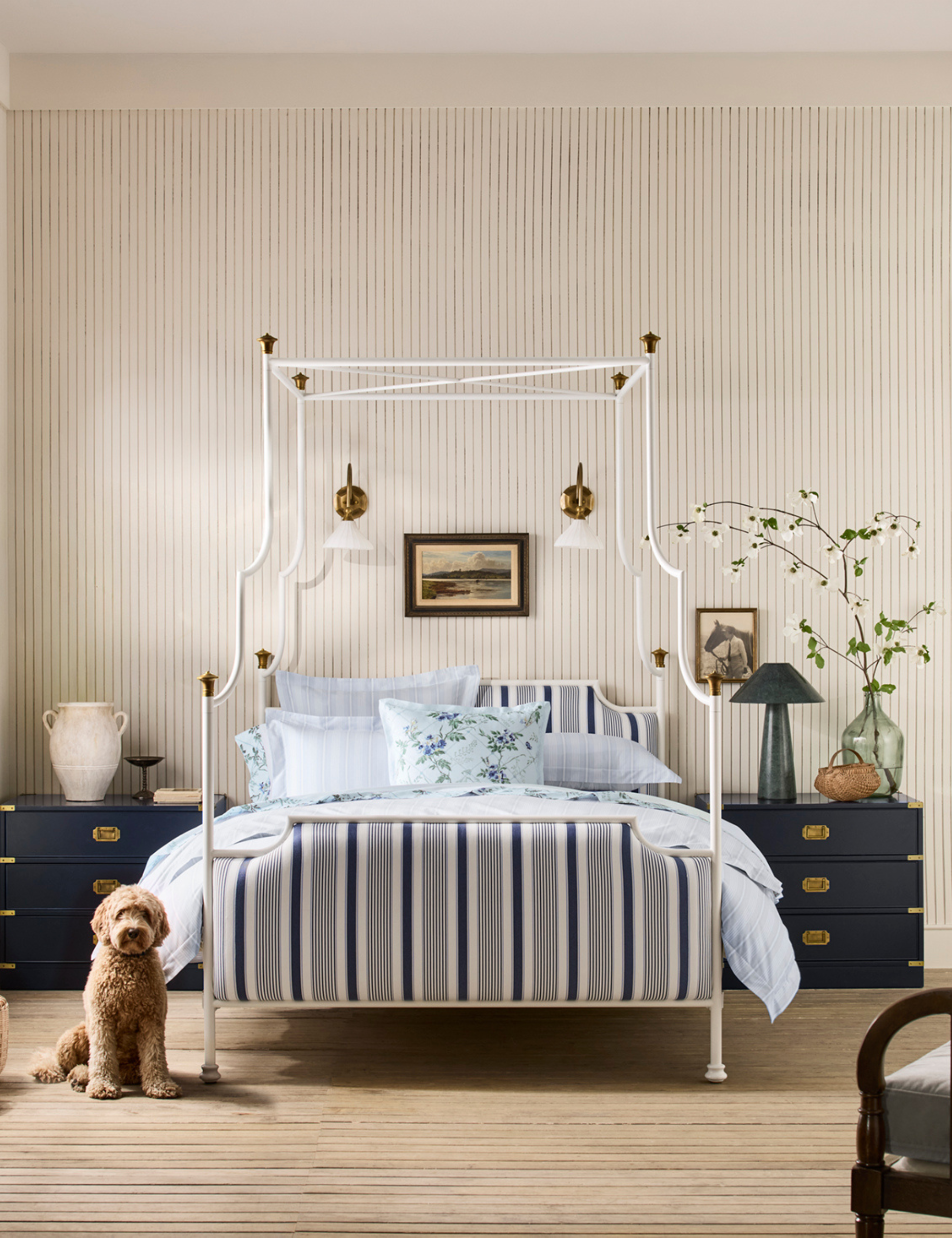 Bright, cheerful, pattern-filled bedroom featuring a four-poster canopy bed with striped upholstery