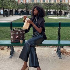 a woman wears cap-toe ballet flats