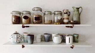 open display shelving with jars and mugs on it