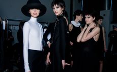 Female models dressed in the Emporio Armani A/W 2014 backstage of the fashion show