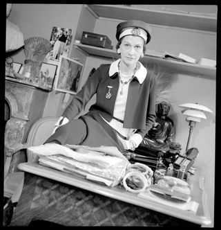 Coco Chanel photographed in her office in Paris