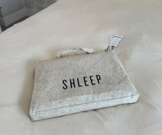 A bag of Shleep bedding on a Shleep fitted sheet.