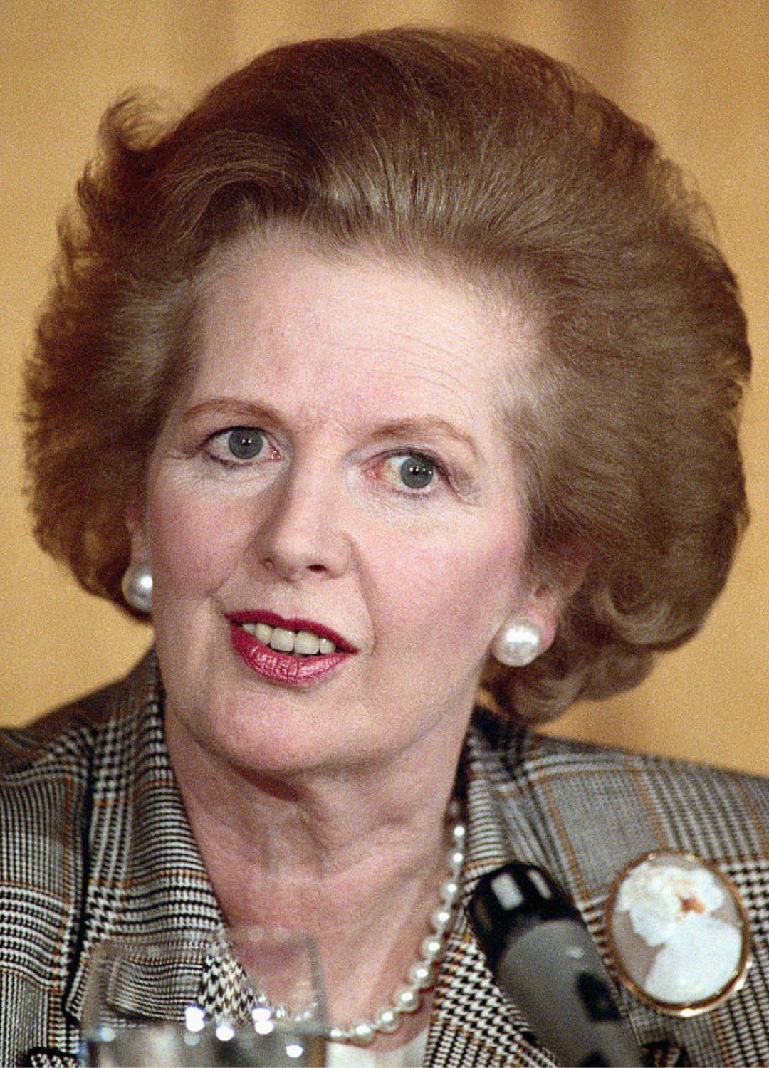 Margaret Thatcher in front of an orange background