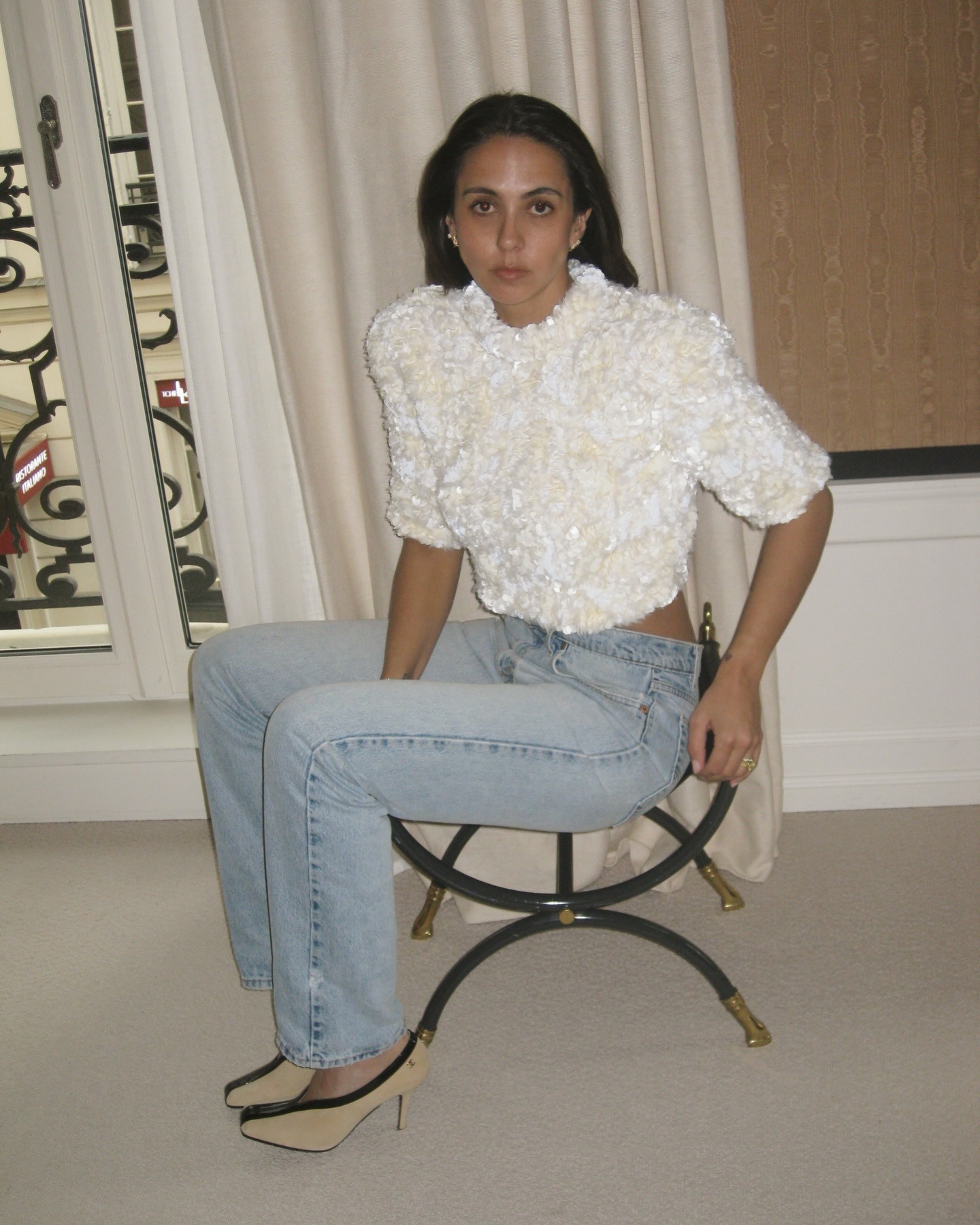 Hanna Marzouki Widlund wearing jeans with sequin top and Chanel heels.