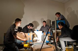 Researchers conduct their leaping lizard experiment, video-recording the Agama lizard taking leaps toward a vertical wall. Shown from left to right: Evan Chang-Siu, Daniel Cohen, Ardian Jusufi, Thomas Libby and Deborah Li.