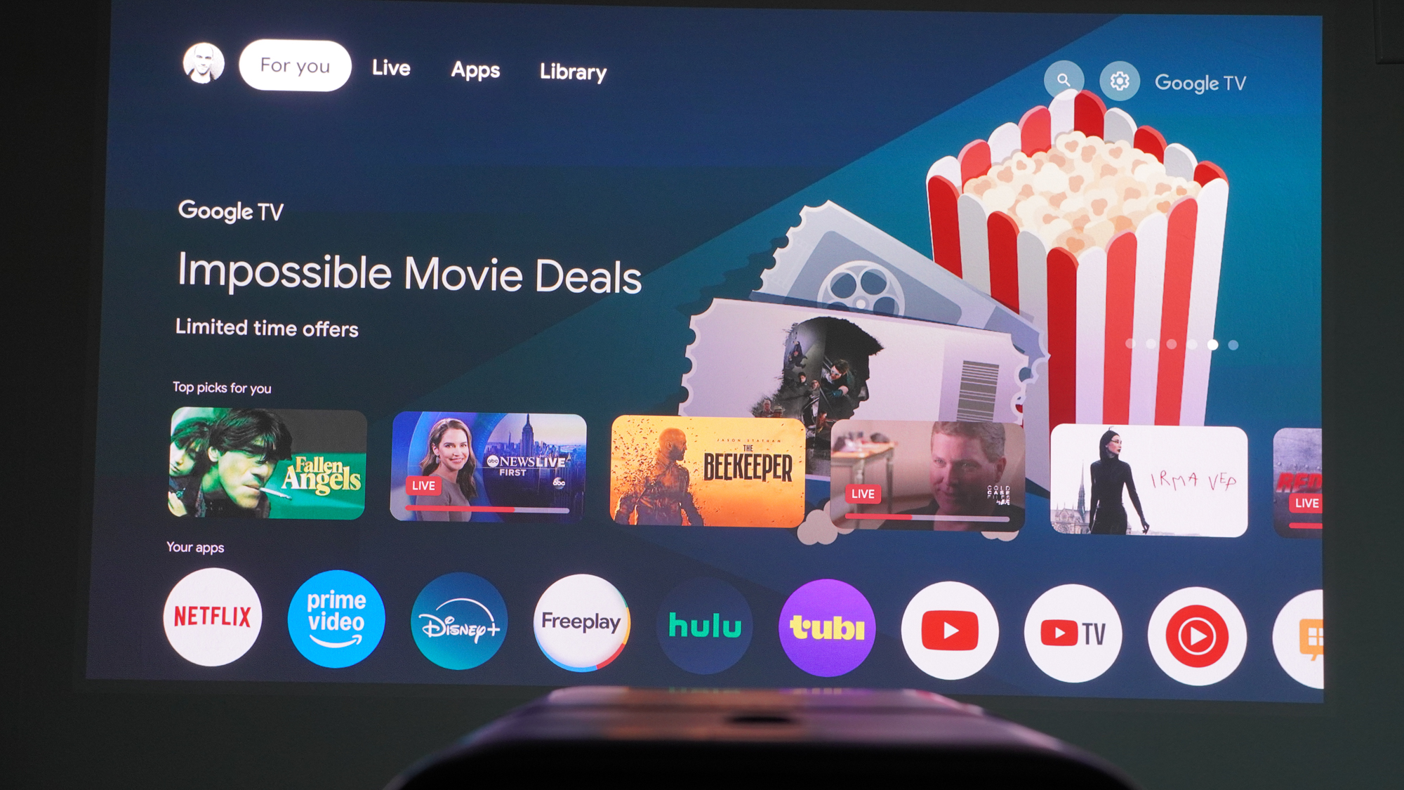 Google TV interface projected onto a wall by the Anker Nebula X1 projector.