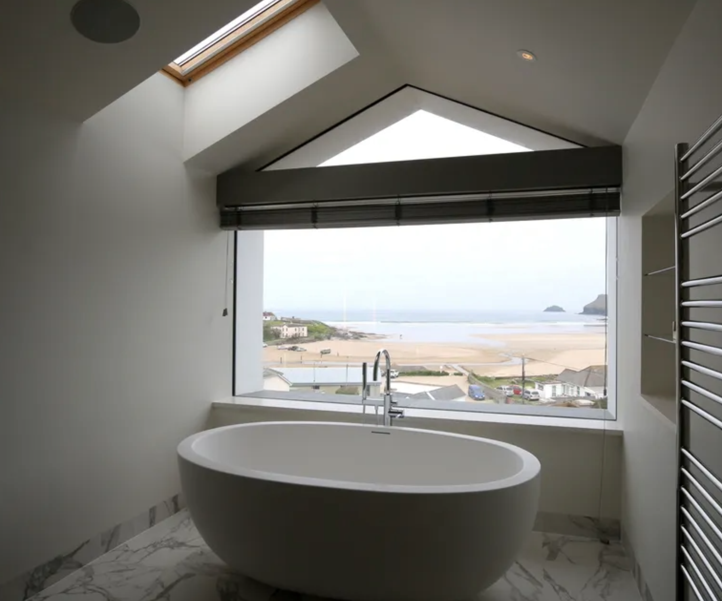 a bathroom picture window with a venetian blind